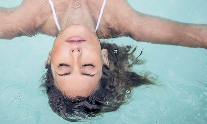 Woman relaxing in the swimming pool